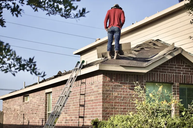 Professional roofer working on a residential roof in Timberlake